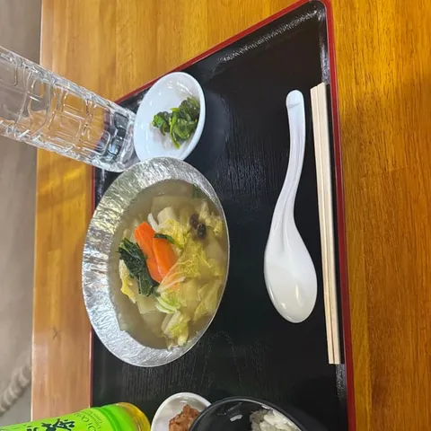 A bowl of chanko-nabe served with rice at a sumo house