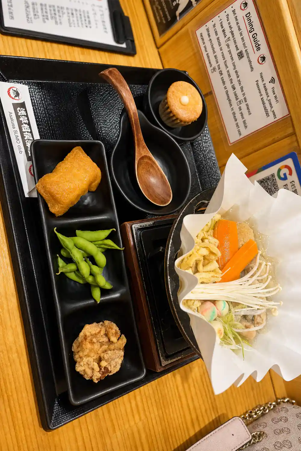 Japanese meal set with multiple dishes in black trays