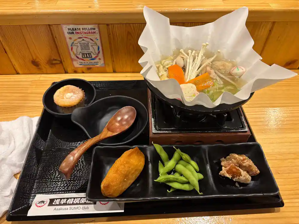 Sumo ring with red carpet and food tray visible