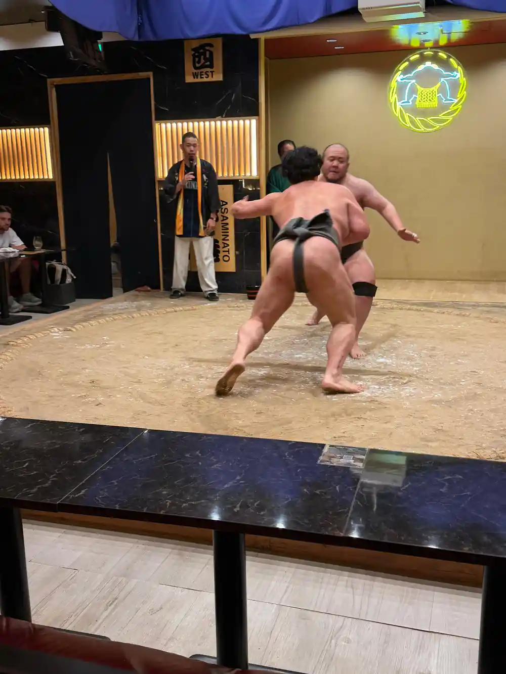 Sumo wrestler in match stance at training venue