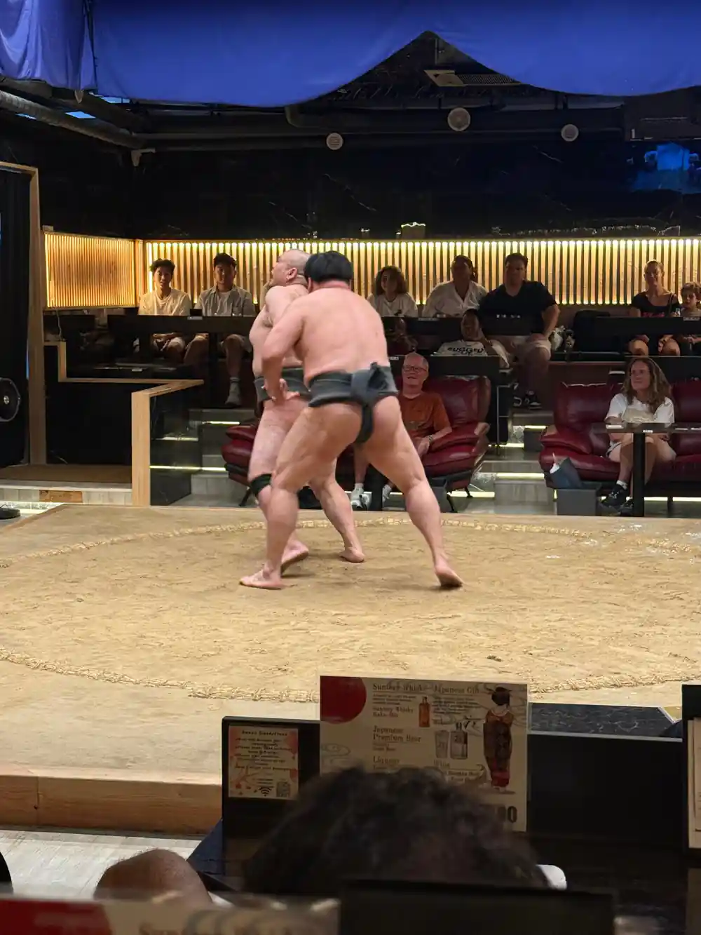 Sumo wrestler in traditional loincloth performing in ring