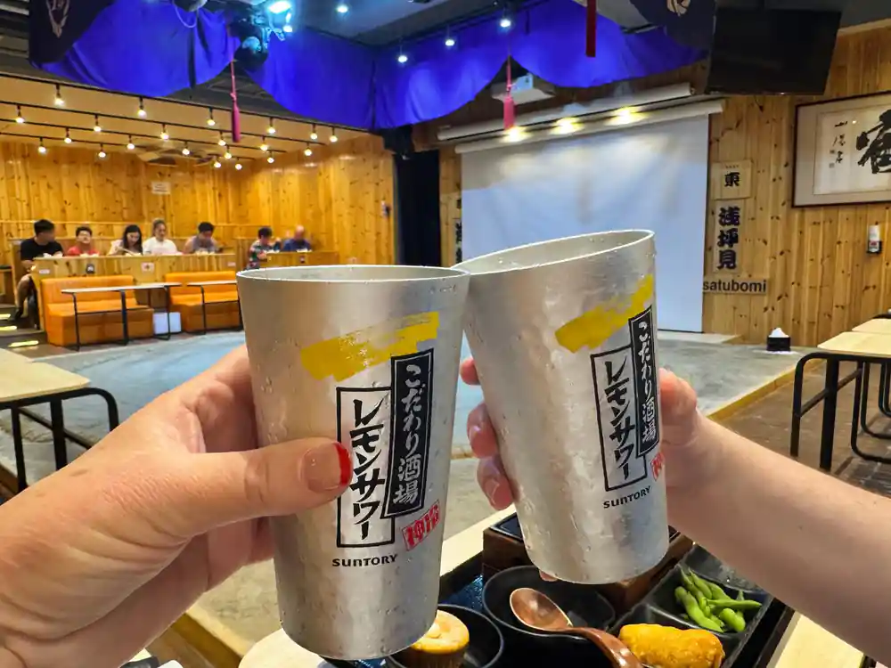 Two beverage cups with Japanese text at venue