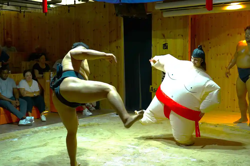 Two sumo wrestlers grappling during match competition