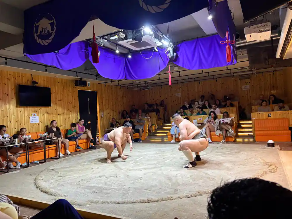 Two sumo wrestlers positioned for match engagement